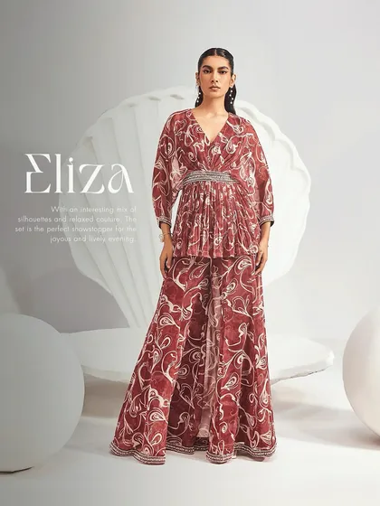 The Eliza Sharara Set, a beautiful mix of relaxed couture and intricate detail. This printed ensemble features a pleated peplum kurta with an embellished waistband, paired with flared kali sharara pants for a lively evening look.