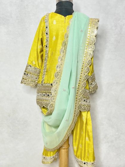 The back view of the yellow mirror work kurta set, showing the detailed craftsmanship.