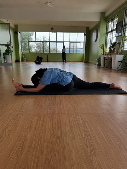 The final stage of the forward fold in Hanumanasana. This deep surrender in the pose is the culmination of consistent practice and patience, releasing tension from the hamstrings and hips.