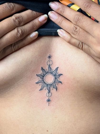 A clear, healed shot of the sun sternum tattoo. Proper aftercare ensures that fine-line work stays crisp and clean.