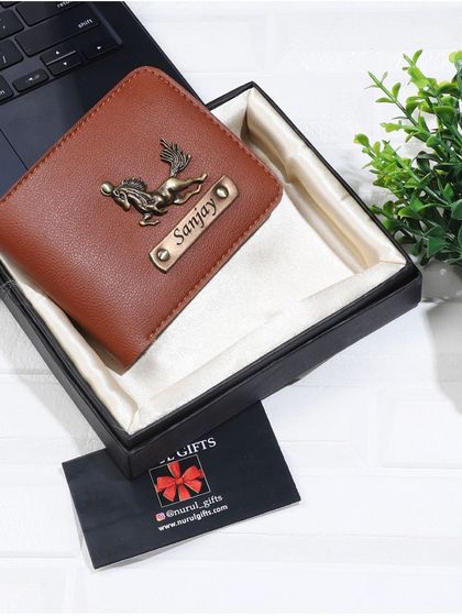 A tan leather wallet personalized with a running horse charm, ideal for someone with a free spirit.