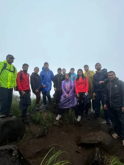 A group photo from our Kurinjal trek, with everyone in raincoats, ready for the monsoon adventure.
