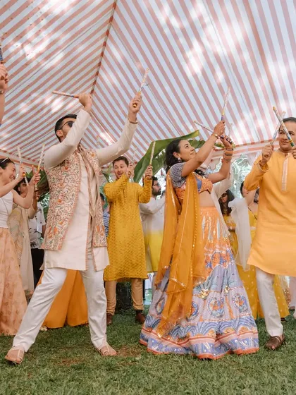 A candid moment from a Dandiya-themed Haldi carnival. The joy on everyone's faces as they dance with dandiya sticks is what makes these events so special.