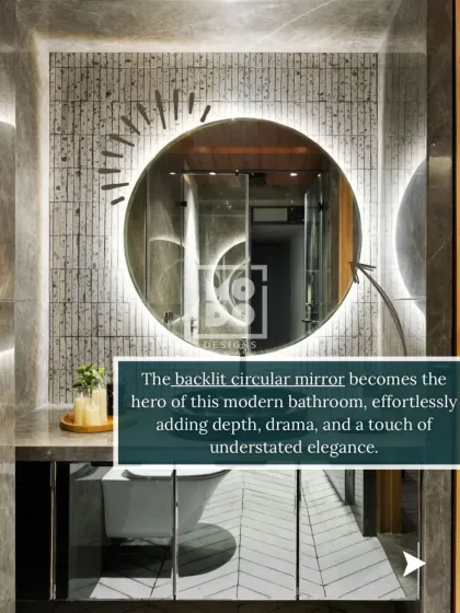 The backlit circular mirror becomes the hero of this modern bathroom. It effortlessly adds depth, drama, and a touch of understated elegance to the space.