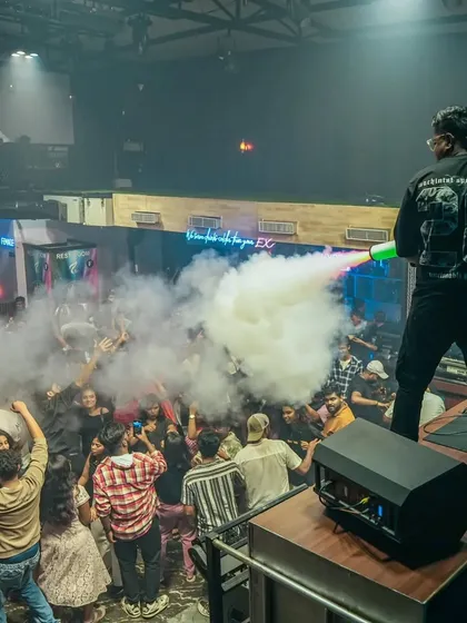 The crowd's reaction is everything. Here they are, hands up, as the CO2 smoke washes over them during a high-energy moment.