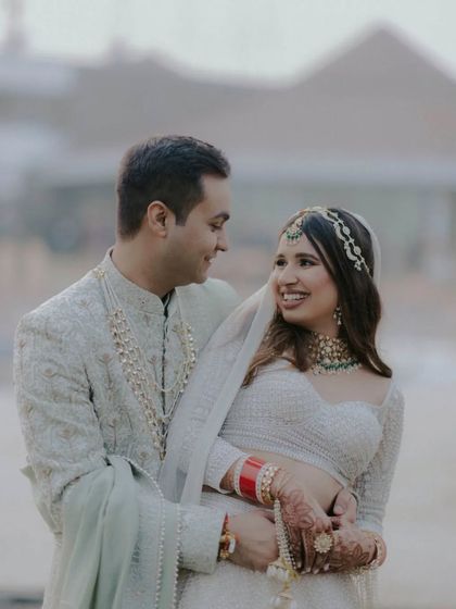 A perfect love story captured in a single frame. This candid shot of the couple looking at each other with pure affection is what modern classics are made of.