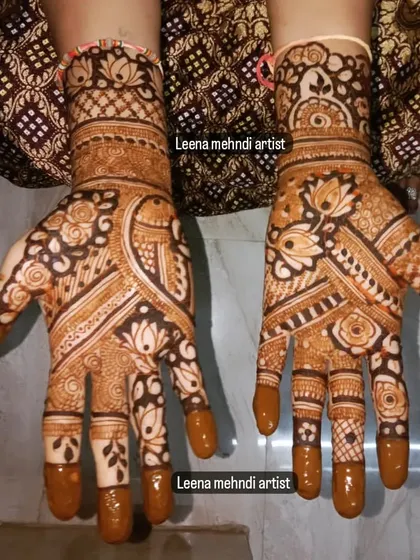 A beautiful, full-coverage design for a wedding guest. The pattern is a mix of floral and traditional Indian motifs, with a rich color from the henna stain.