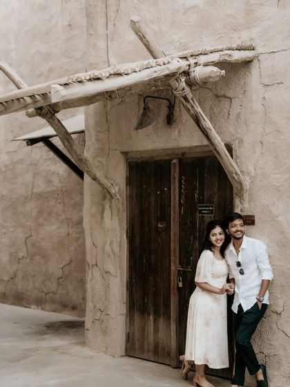 A sweet and simple pose against a traditional wooden door in a heritage area of Dubai.
