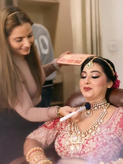 Here I am, in my element, adding the final touches for a beautiful bride. I believe in a hands-on approach, whether it's for my brides or my students, ensuring every detail is perfect.