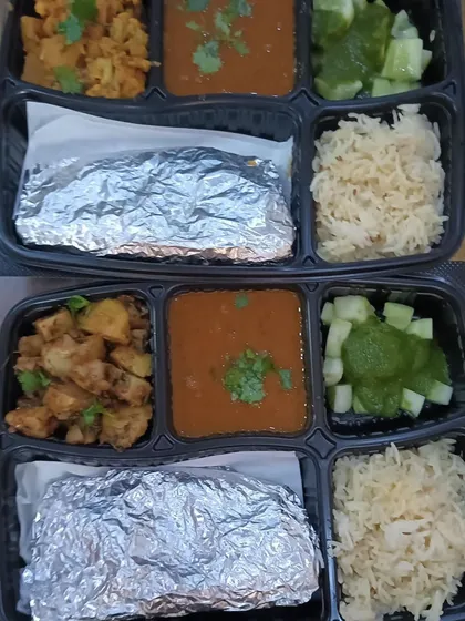 This thali features a comforting combination of rajma and aloo gobhi. It's a wholesome and filling meal, perfect for a hungry student or office goer.
