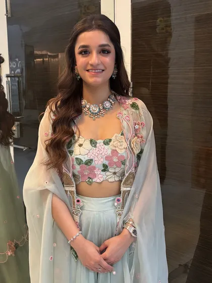 The full view of the client's look. The soft, open hairstyle is perfect for the delicate and feminine vibe of her outfit.