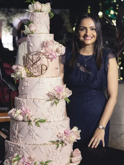 Standing next to one of my grand creations is always a special moment. This six-tiered blush pink wedding cake, detailed with intricate lace and sugar flowers, was a joy to design and create. It’s a privilege to bring such sweet, towering dreams to life for a couple's special day.