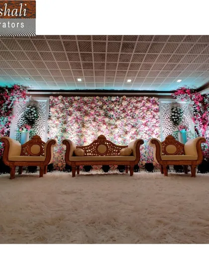 For a grand and luxurious feel, I can create a full floral wall backdrop. This stage design includes elegant seating for the main guests and is perfect for making a big statement at weddings or large parties.