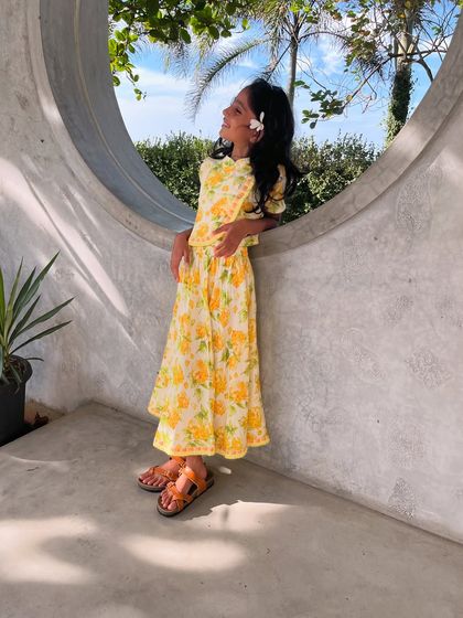 Basking in sunshine and blooms! This vibrant yellow floral set is perfect for sunny day adventures. It's as comfortable as it is cute, letting her twirl in style all day long.