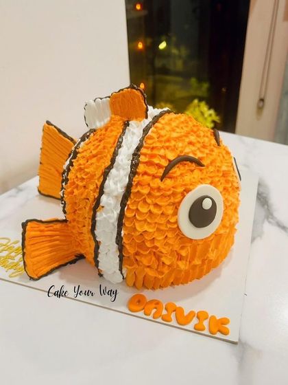 Another view of the sculpted Nemo cake, showing the detailed piping work that creates his fish scales.