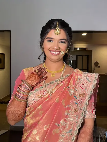 A happy wave from my Mehendi bride. Her makeup is fresh and minimal, allowing her natural beauty and the intricate henna to take center stage.