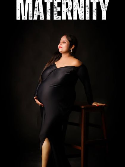 A classic studio portrait of a mom-to-be in a black gown, looking thoughtfully to the side. The simple dark background and focused lighting create an elegant and timeless image.