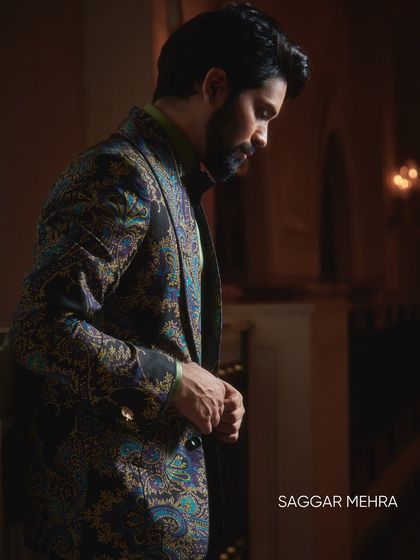 A profile of Ankush Bahuguna in the printed jacket, capturing the mood and texture of the fabric. The blend of light blue, grey, and deep blue offers a sophisticated yet bold aesthetic.