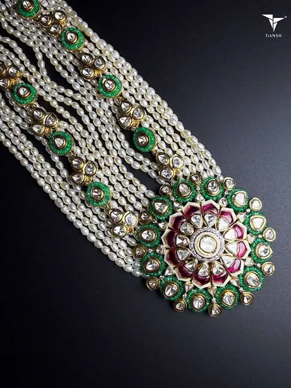 If heritage could be explained in one piece, this would be it. This traditional Polki haar, with its intricate meenakari work and layers of pearls, is crafted to feel like a family heirloom from the very first day you wear it.