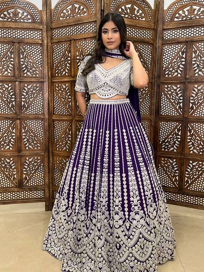 A stunning deep purple lehenga with intricate silver embroidery. The unique color and heavy work make this a standout pre-loved piece for a sangeet or reception.