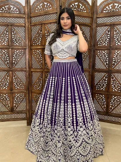 This deep purple lehenga with silver embroidery is a regal and striking choice for an evening function.