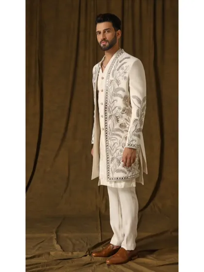 A side profile of the Pragyan shrug set, showing the layering and the elegant fall of the embroidered jacket.