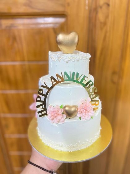 A hand-held view of our mini three-tier anniversary cake.