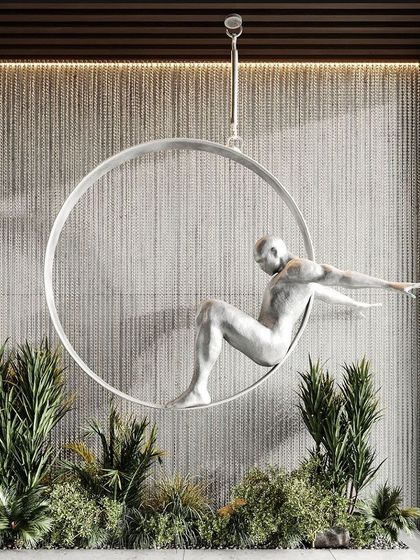 Art meets nature in this unique installation. We integrated a modern sculpture within a bed of lush faux greenery, creating a botanical canvas that is both a garden and an art piece.