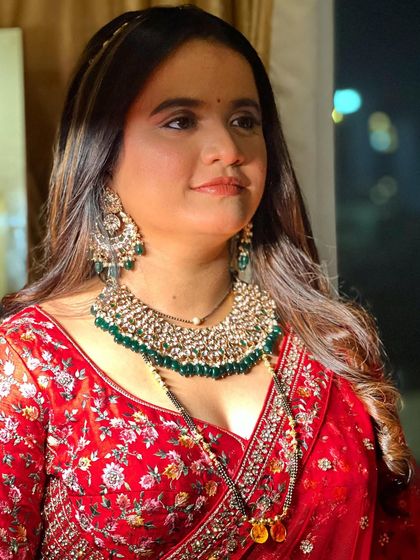 A glamorous look for a bride in a red lehenga. The makeup is bold and beautiful, perfect for making a statement.