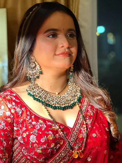 A glamorous look for a bride in a red lehenga. The makeup is bold and beautiful, perfect for making a statement.