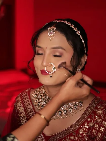 A close-up of the makeup application, showing the precision and care that goes into every look.