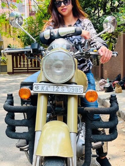 A graduate looks confidently into the camera, ready to ride. She embodies the strength and spirit of our community.