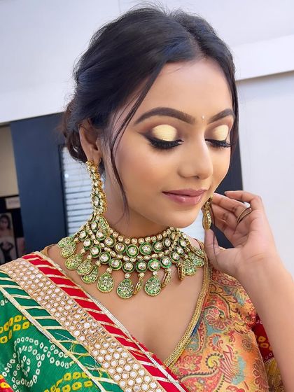 A vibrant bridal look with a pop of yellow on the eyes, perfect for a Haldi or Mehendi ceremony. I encourage my students to experiment with color to create unique festive looks.