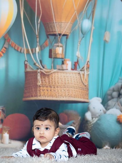 This baby is enjoying tummy time amidst the clouds and hot air balloons.