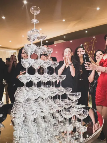 Another angle of the champagne tower moment, capturing the joy and excitement of the celebration. These are the moments that make an event truly memorable for guests.