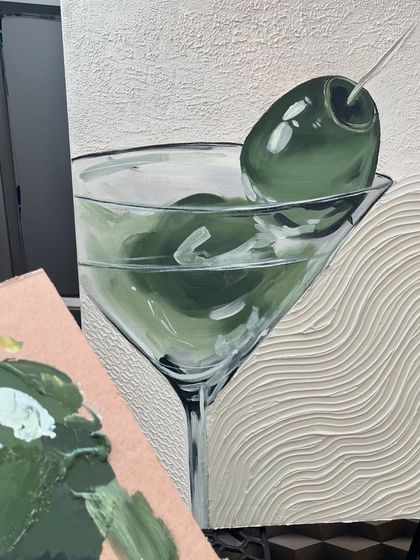 The martini painting next to my paint palette, showing the shades of green I mixed to get that perfect olive color.