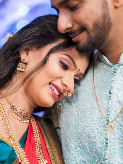 A close-up capturing the bride's beautiful makeup, jewelry, and the contentment in her smile.