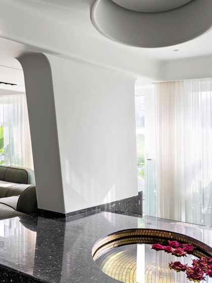 The kitchen in The Sanctuary project is designed for communal cooking and dining. A large island and ample counter space make it ideal for workshops and gatherings, while the open layout connects it to the surrounding gardens.