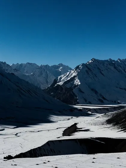 A vast, snow-covered valley in Spiti, showing the immense scale and quiet emptiness of the winter landscape.