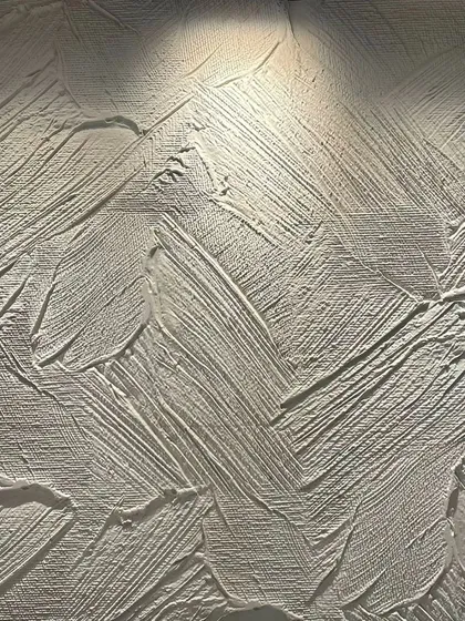 A close-up of a hand-applied textured finish, showing the depth and character created by abstract brushstrokes.