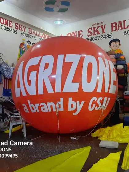 This bright orange advertising balloon was made for 'Agrizone'. The bold color and large text ensure it stands out, perfect for agricultural brands at expos or dealer locations.