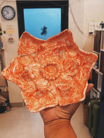 This star-shaped platter with a vibrant orange marbled pattern is another of Apurva's stunning Nerikomi creations. It’s a true feast for the eyes.