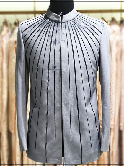 A unique grey bandhgala jacket with black vertical stripes creating a modern, graphic effect. This is a high-fashion piece for a trend-setting client.