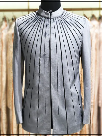 A unique grey bandhgala with radiating lines of black embroidery. This is a very modern and artistic take on the classic silhouette.