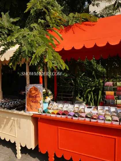 We set up vibrant stalls for guest favors, such as this bangle stall, which adds to the festive mela atmosphere.