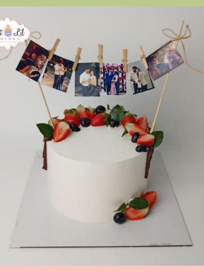 A cake that holds memories. This unique design features a clothesline of printed photos, surrounded by fresh berries, perfect for a personal and heartfelt celebration.