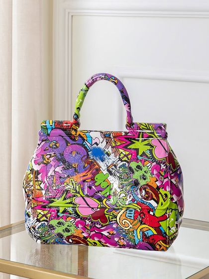 Shaped like a handbag but designed as a sculpture, this piece is covered in vibrant, graffiti-style art. It’s a fun and fashionable statement piece that blurs the line between decor and pop culture.