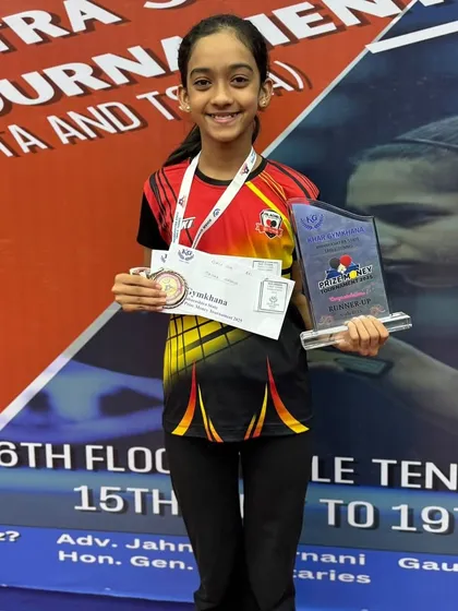 We nurture talent from a young age. Here is our promising U-15 player, Saisha Madhur, proudly displaying her silver medal and trophy from the Khar Gymkhana State Tournament, a testament to her hard work and our foundational coaching.