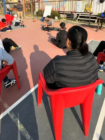 Our athletes listen intently during a nutrition and strength training session. We believe knowledge is just as important as physical skill.