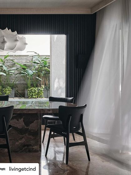 The dining room at The Grove Residence, featured in Livingetc. The image highlights the play of light and shadow, and the connection to the outdoor courtyard.